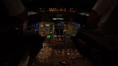 two pilots in the cockpit of a jet airplane airbus during a night fligth