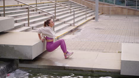 woman doing exercise outdoors on steps