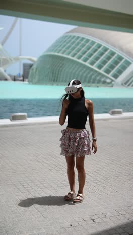 woman wearing vr headset in front of modern architecture