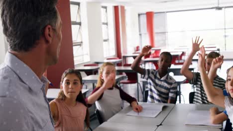 schoolkids raising hand in classroom 4k