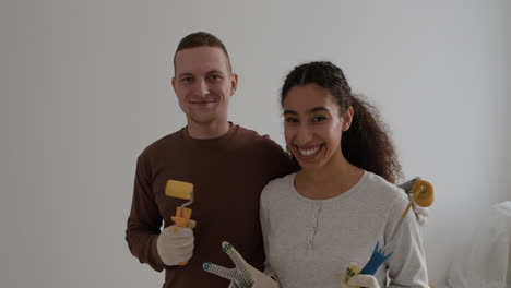 happy couple painting their new home together
