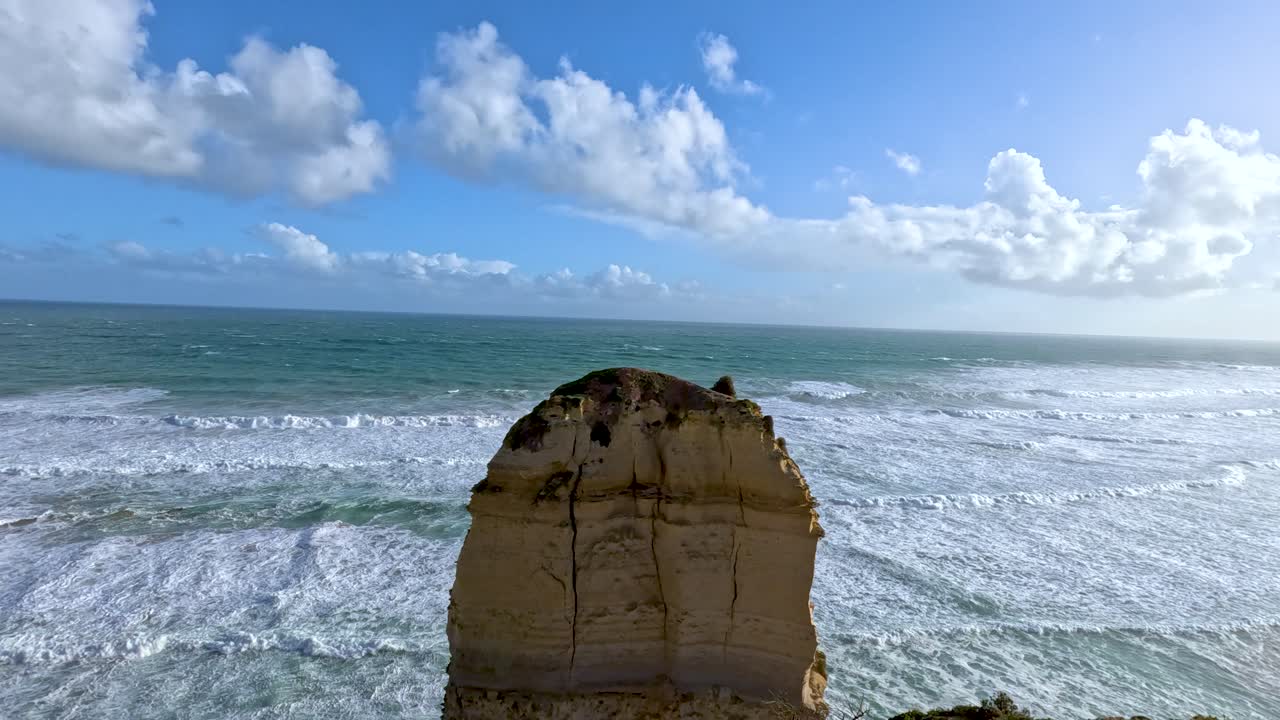 una vista panorámica de los doce apóstoles a lo largo del gran camino del océano, mostrando dramáticos acantilados y olas del océano bajo un cielo brillante