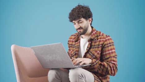 Young-man-using-laptop-computer-typing-something-on-keyboard,-preparing-text,-texting,-sending-mail.
