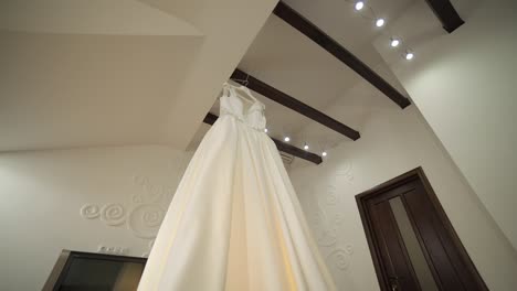 the bride's dress hangs under the ceiling. very beautiful and elegant. wedding