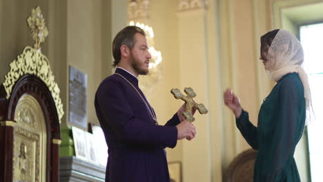 priest holding holy cross