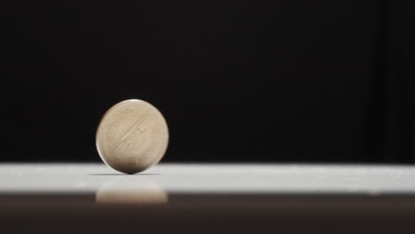 japanese 10 yen coin spinning on table