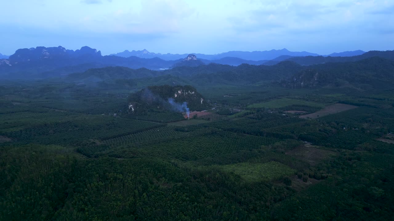 Aerial View of Lush Green Forests and Mountains in a Hazy Landscape
