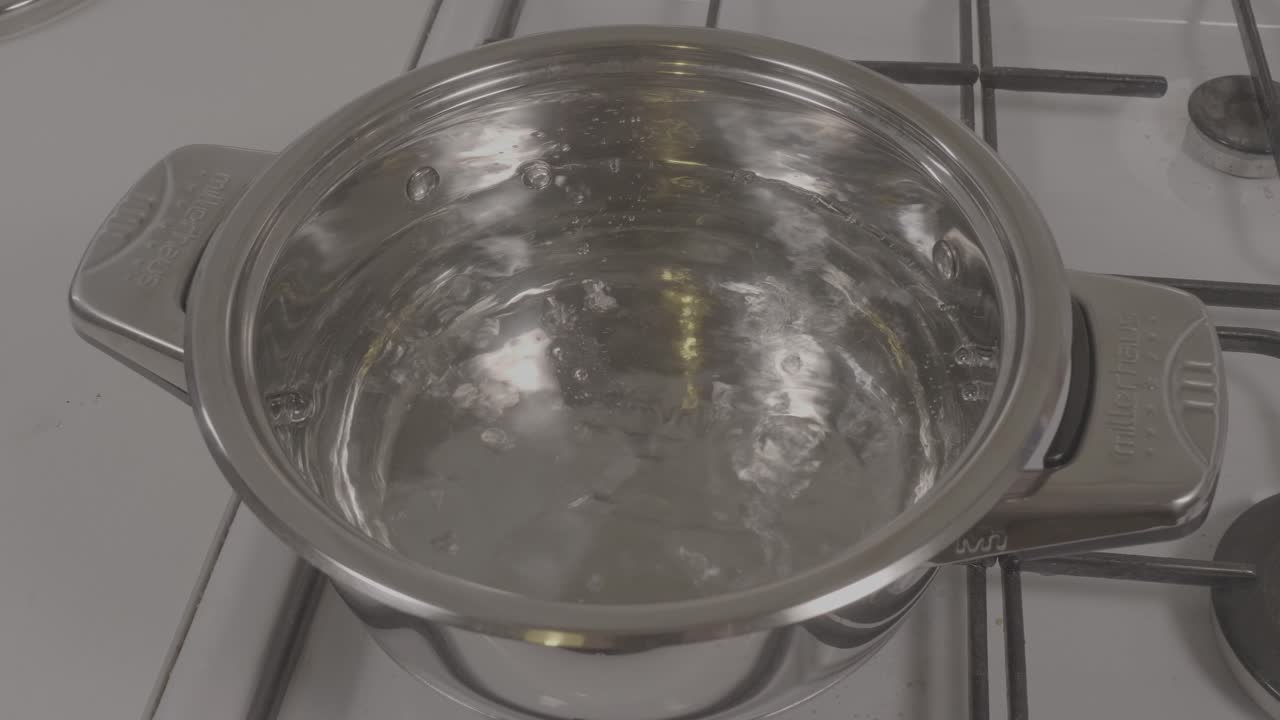 Pot of water boiling on a stove