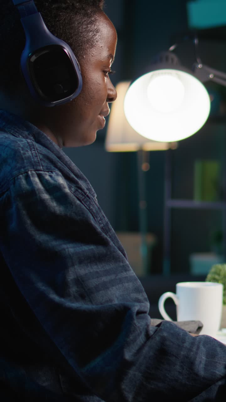 Vertical video Close up on video editor putting headphones on