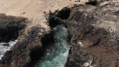 Fantastic-aerial-shot-in-orbit-of-one-of-the-Caletones-arches-located-on-the-island-of-La-Graciosa