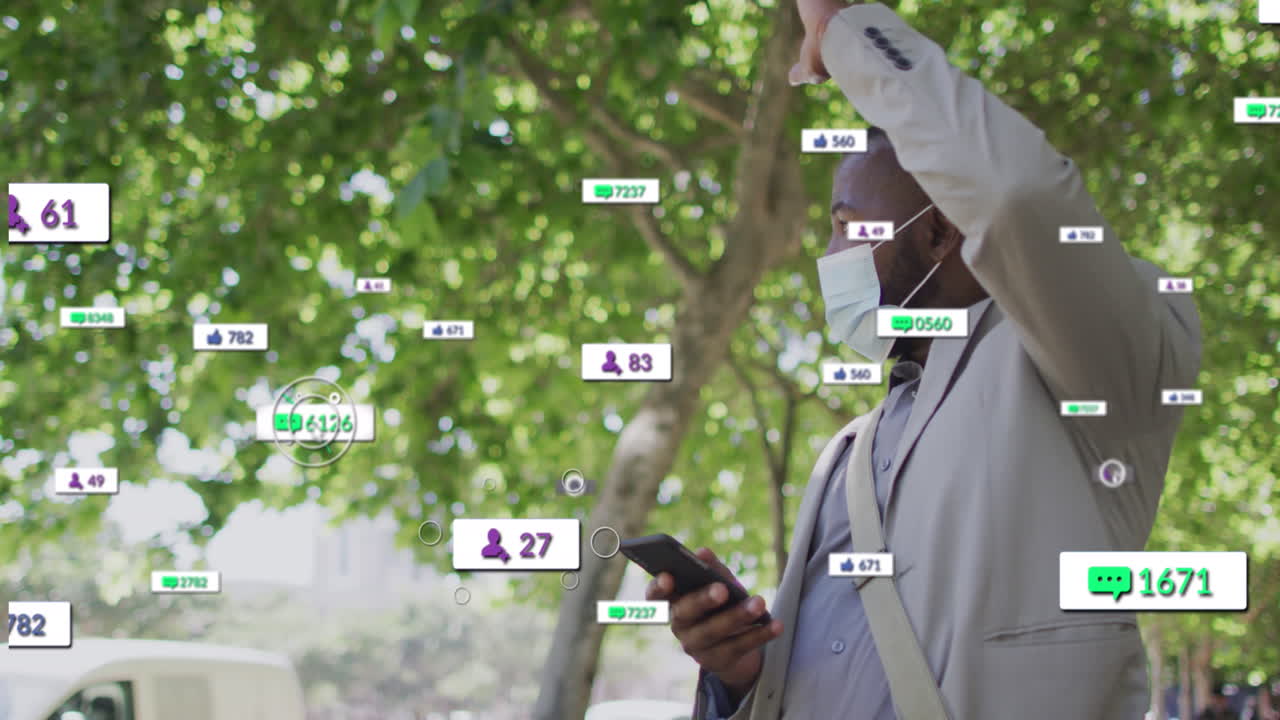 Animation of social media icons over african american man wearing face mask hailing a taxi on street