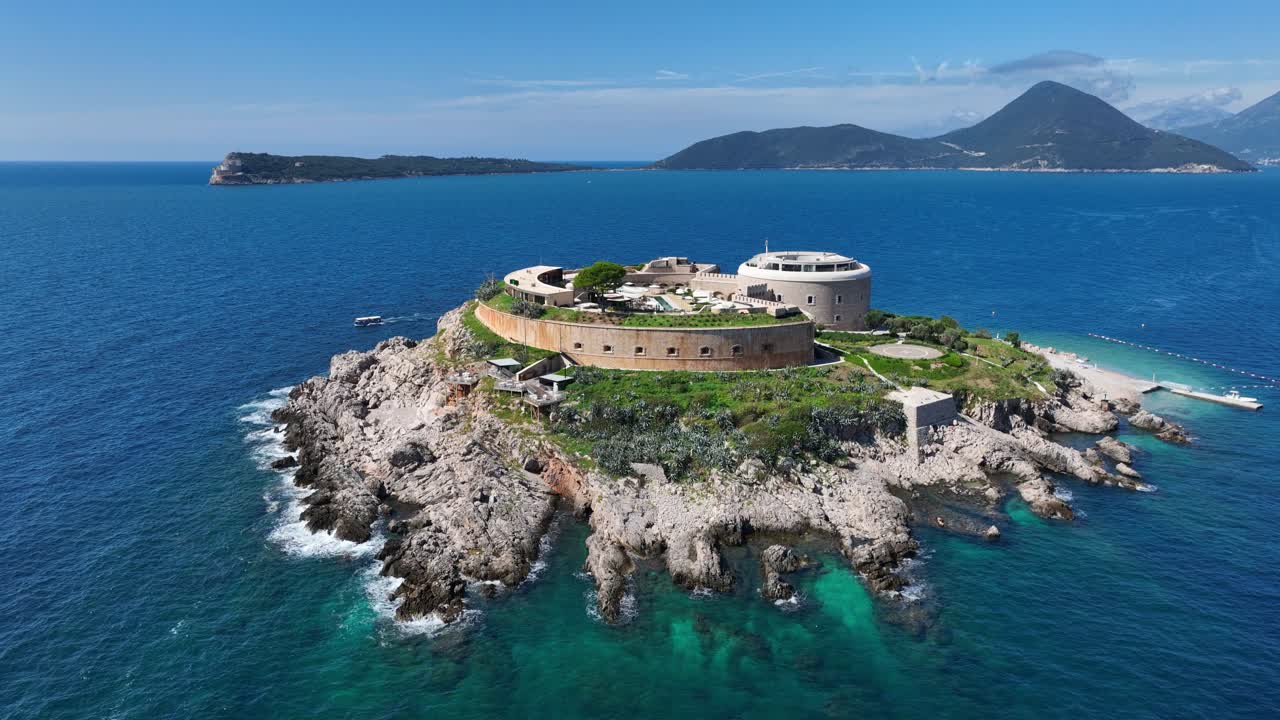 Historic Stone Fortress Of Mamula Turned Hotel On Rocky Island In Adriatic Sea, Montenegro. orbiting drone shot
