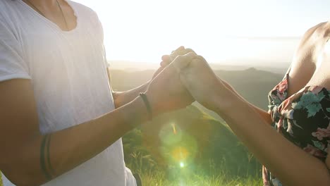 male and female couple holding hands during sunset in valle de anton volcano crater panama, close up orbit right shot