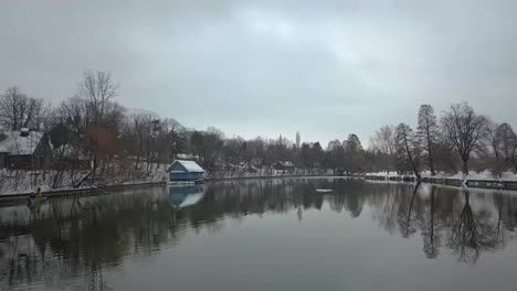 Fly-Over-Icy-Lake-In-Romania-In-a-Quiet-Winter-Day---aerial-shot