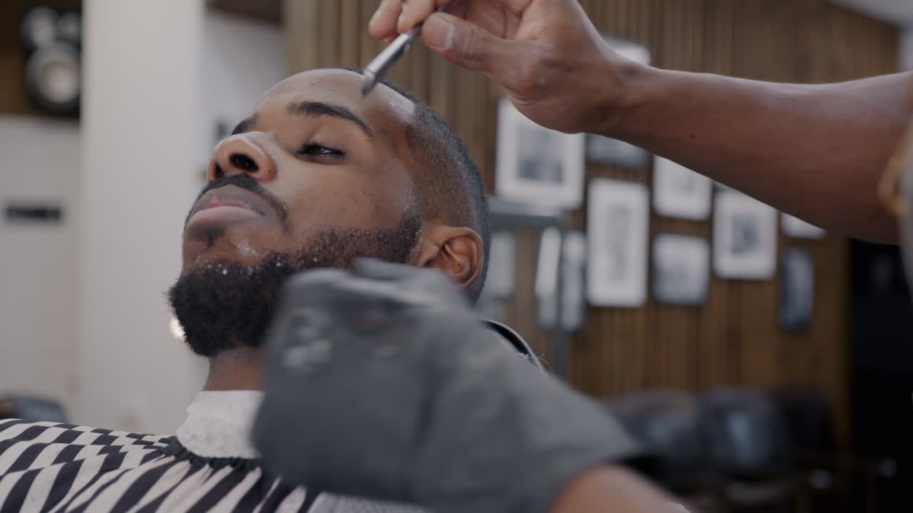 Man Getting a Shave at a Barber Shop