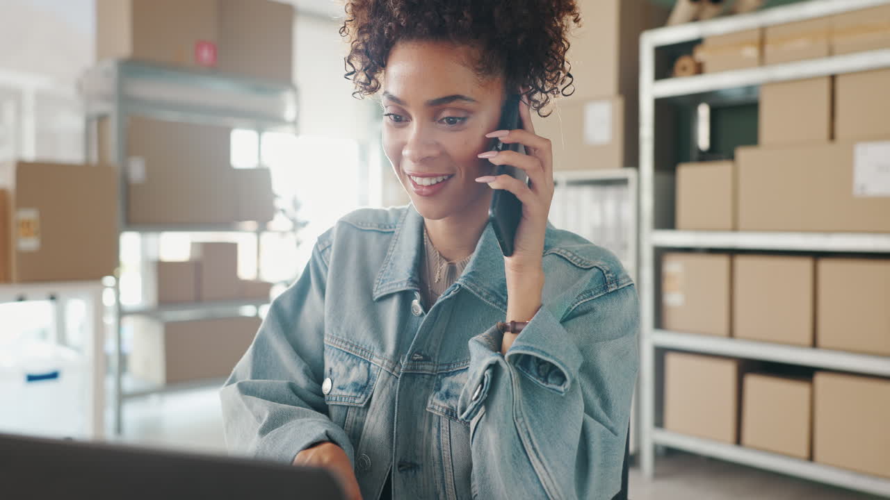 Woman talking on phone in office surrounded by boxes