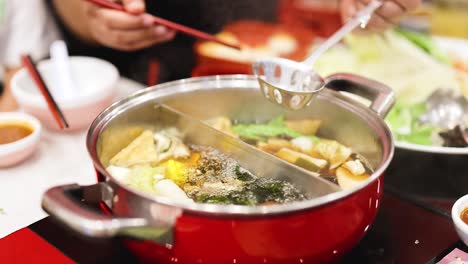 friends enjoying a shared hotpot meal