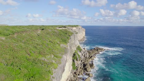 fly over steep cliffs of porte d'enfer in guadeloupe, france