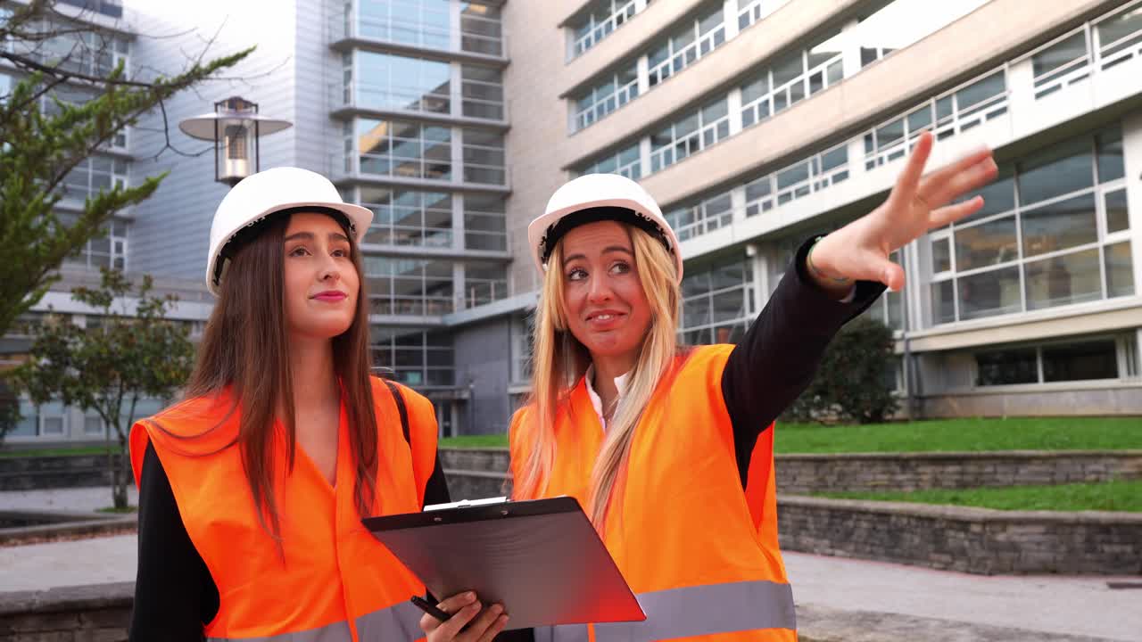 Dwie budowlańczynie omawiające plany na budowie