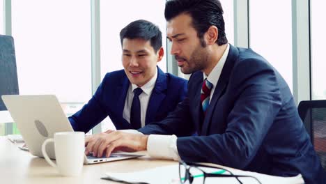 two business people talk project strategy at office