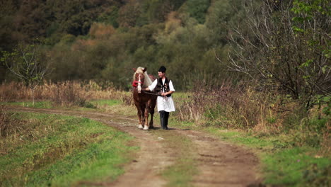 romanian in traditional costume walks next to the horse 5