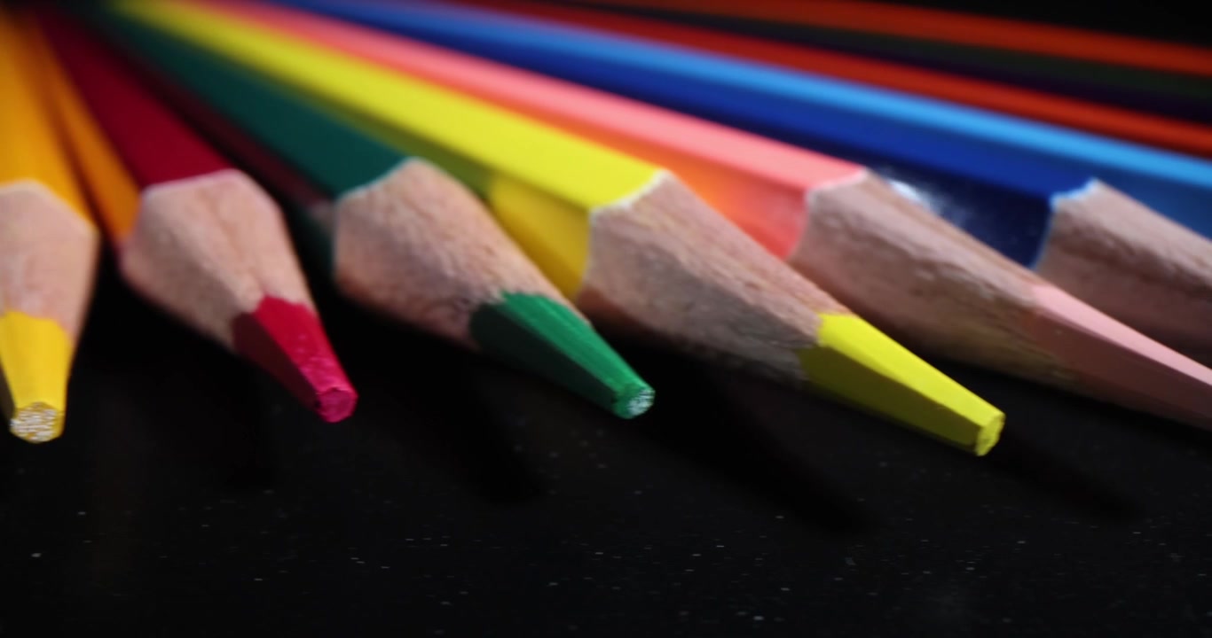 Collection of multicolor crayons for art hobby on black