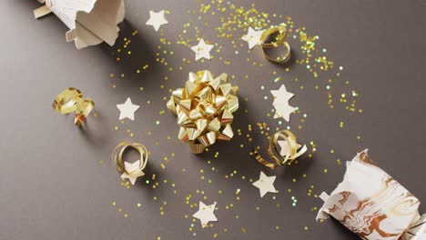 video of christmas crackers, stars and decoration on grey background