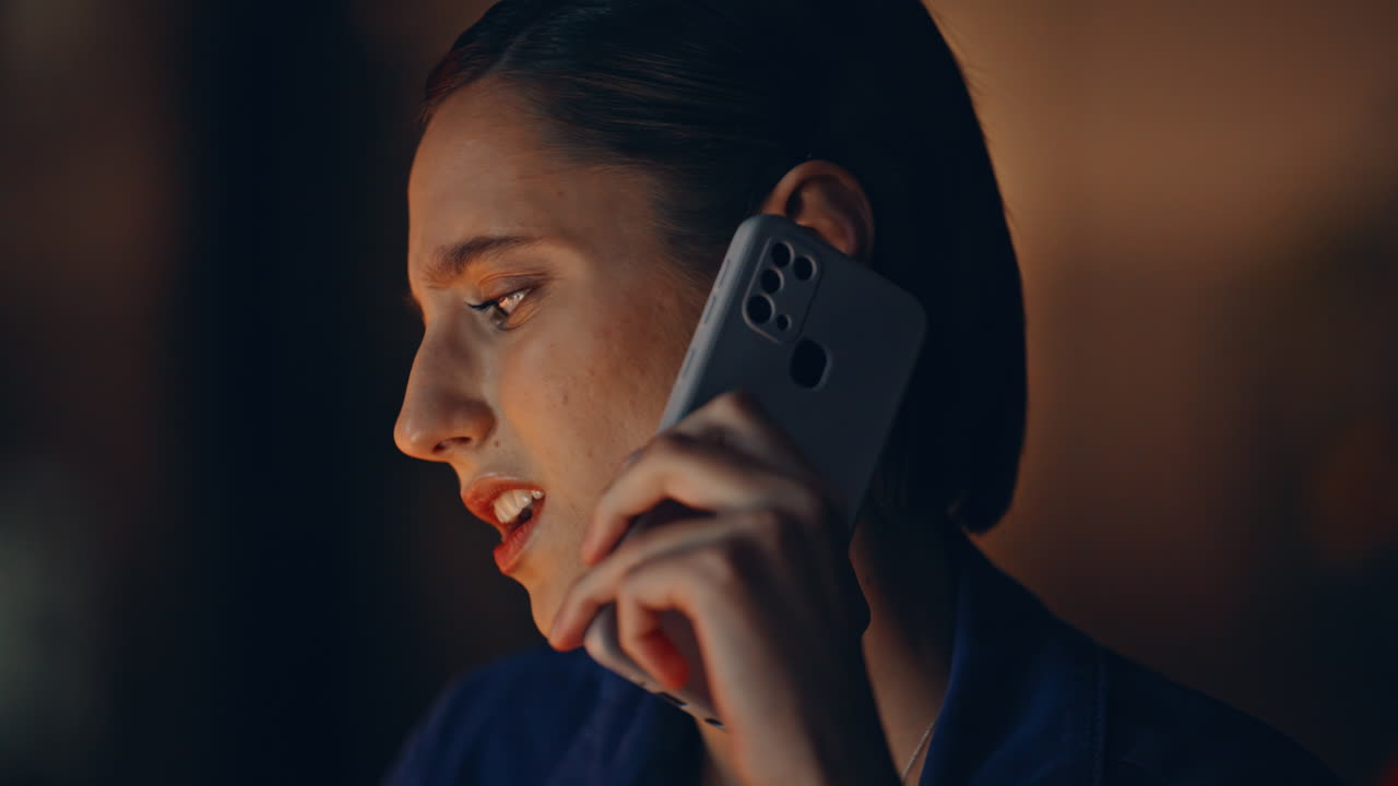 Frustrated woman calling late evening in apartment closeup. Displeased customer