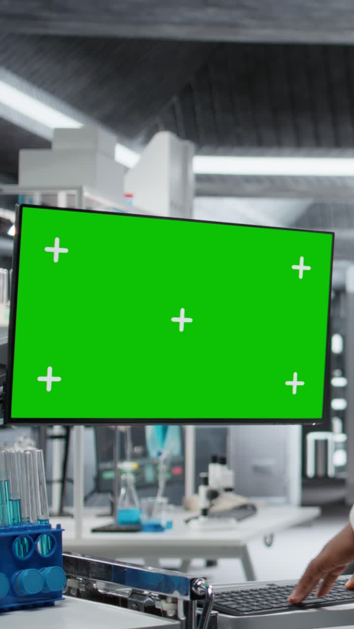 Vertical Video Green screen next to black medic studying data for drug testing in lab