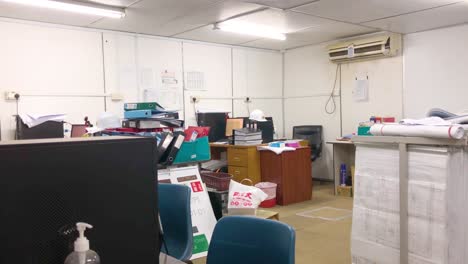 temporary construction office with scattered furniture