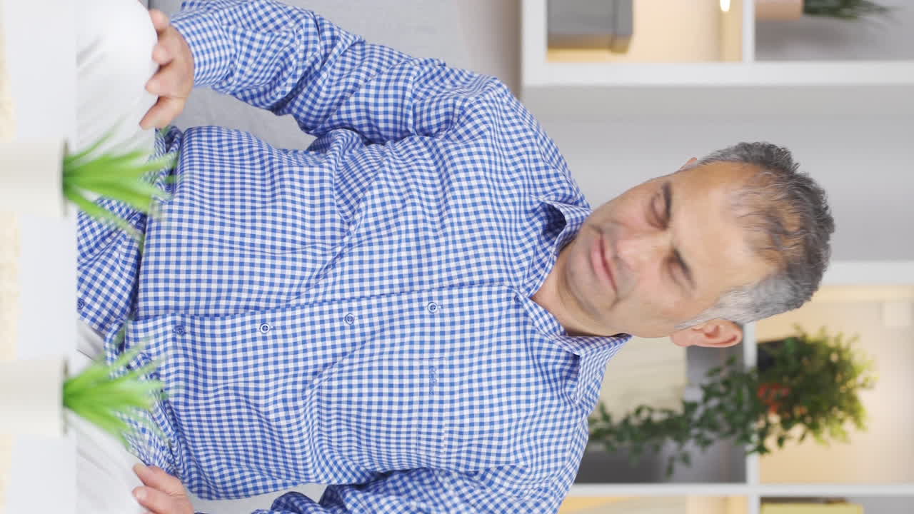 Vertical video of The man is suffering from joint pain.