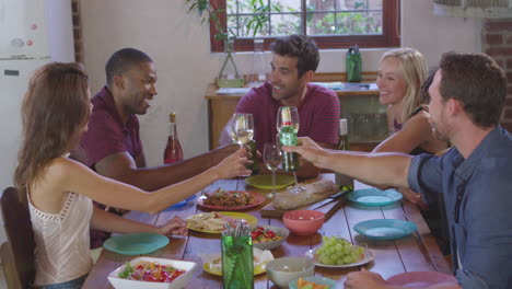 seis amigos adultos jóvenes haciendo un brindis en una fiesta de cena, filmado en r3d