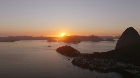 early morning aerial footage of botafogo bay and sugarloaf mountain in the light of the rising sunrise in rio de janeiro