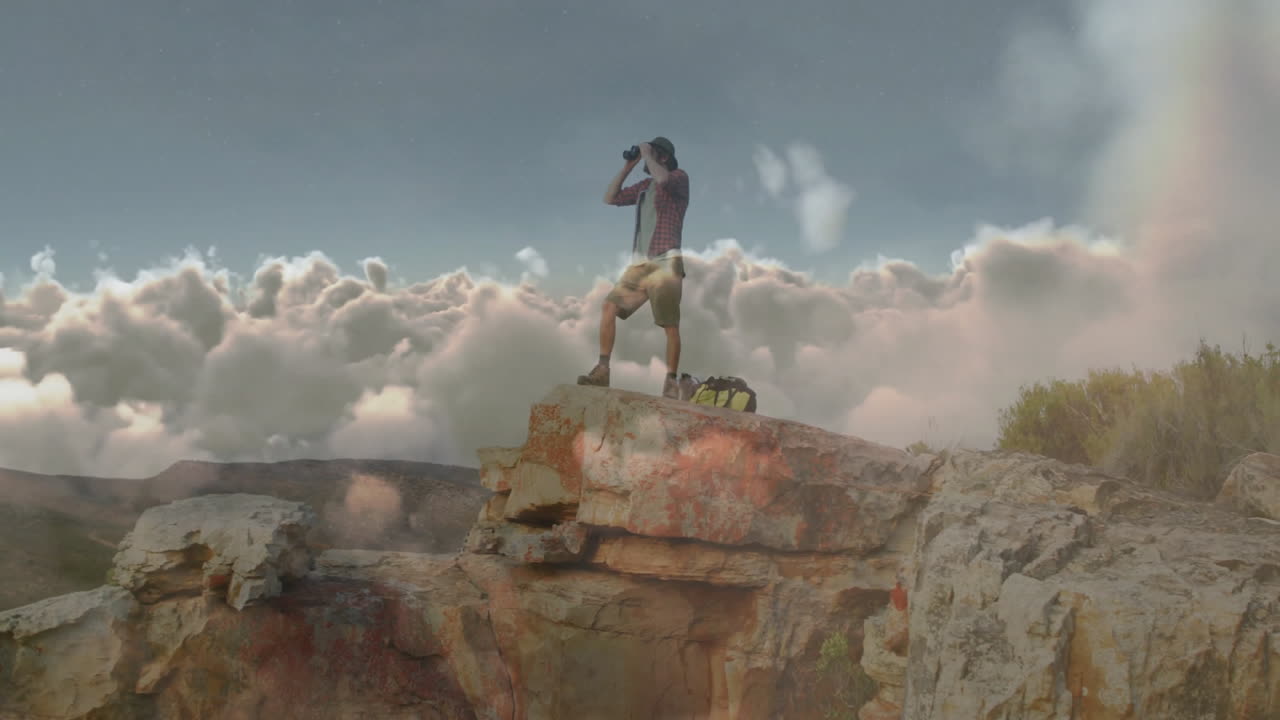 Man scanning clouds through binoculars on rocky cliff in travel industry, with animated map overlay