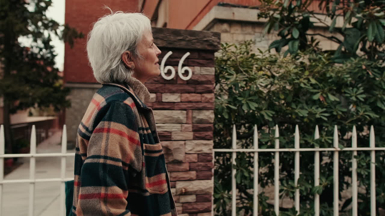 Mature Woman with White Hair Walking on a City Street