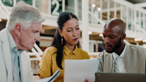 Business-people,-meeting-and-reading-paperwork