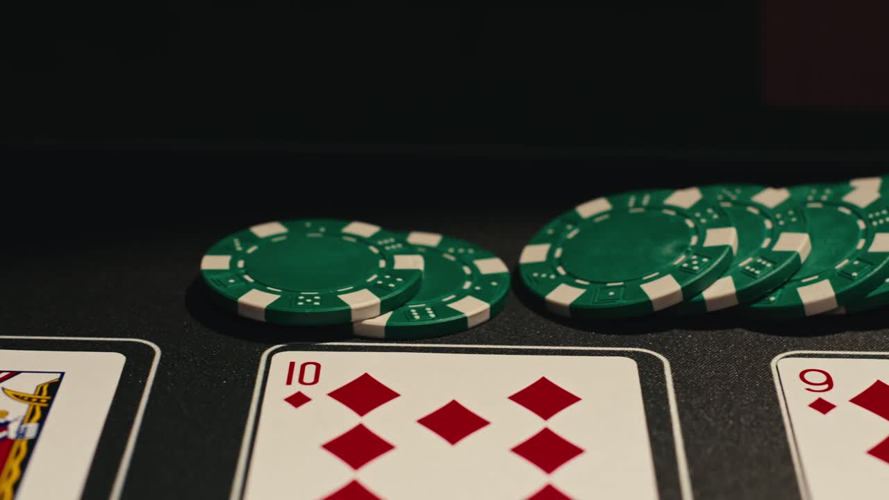 Hands managing poker chips on green table, reflecting intense poker gameplay with the element of chance and skill