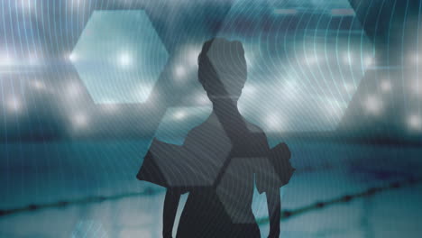 hexagonal shapes and lines against silhouette of boy with inflatable armbands against swimming pool