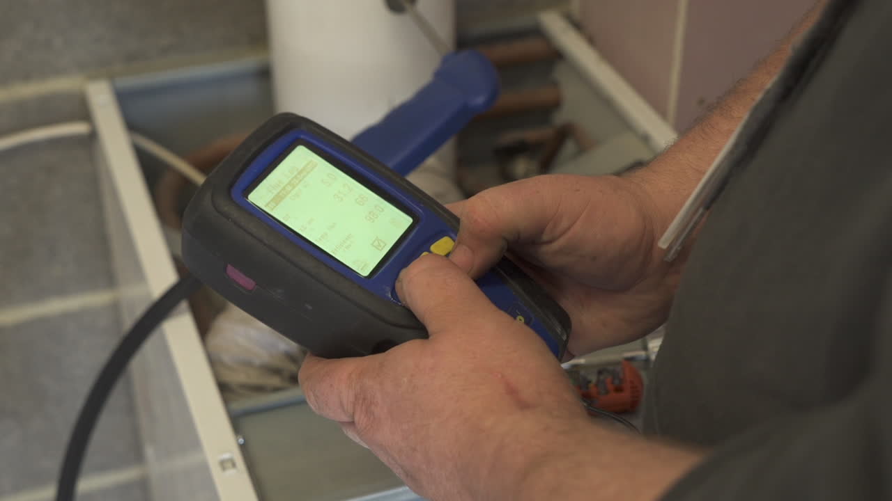 A central heating checking device is used by an engineer