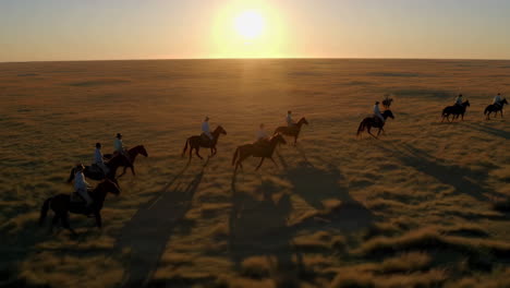 horseback riders on a sunny plains sunset