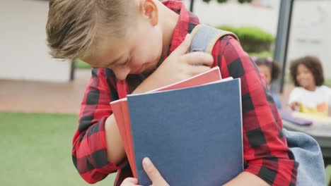 Video-of-sad-caucasian-schoolboy-being-taunted-by-two-diverse-children-in-schoolyard