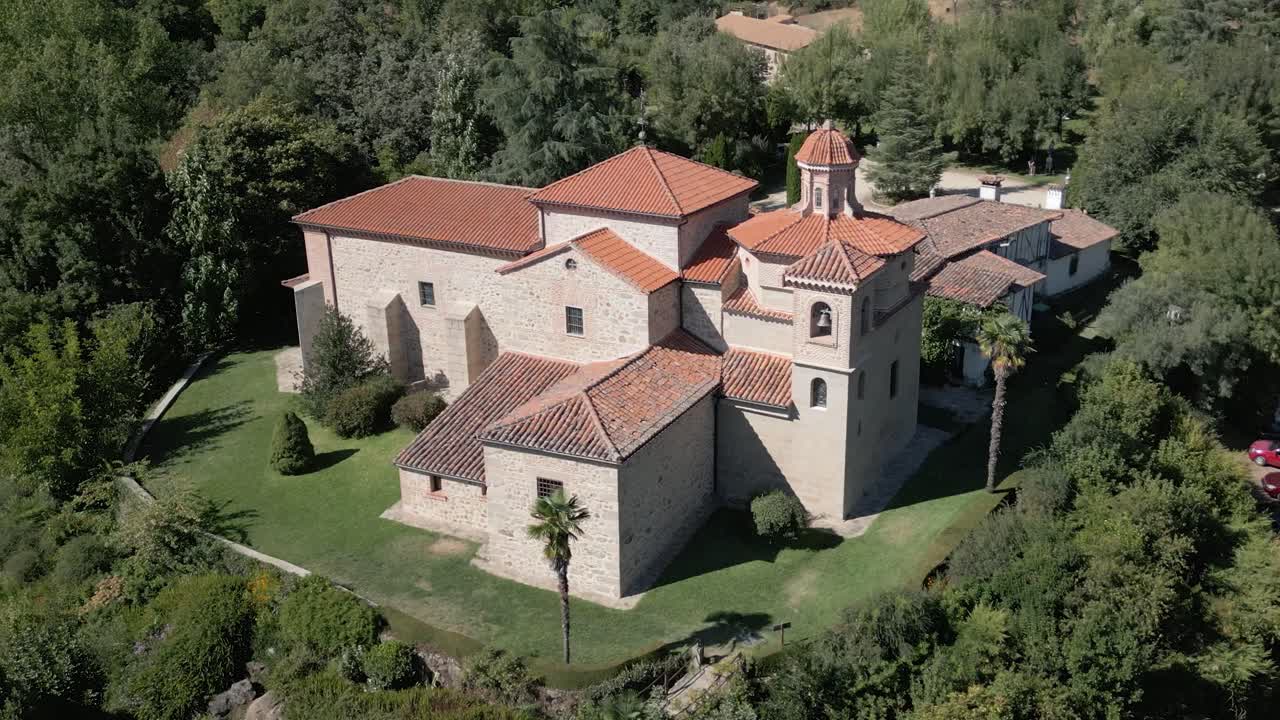 Orbital flight with drone in the majestic sanctuary of the Virgin of Chilla, 16th century, we see its rear structure and its variety of roofs, it is surrounded by gardens, it is fascinating