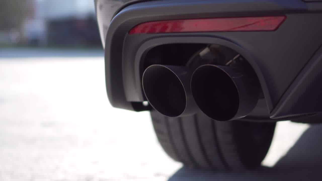 Close up of a car exhausttip. In the video you can see a double tip exhaust from a sports car v8.