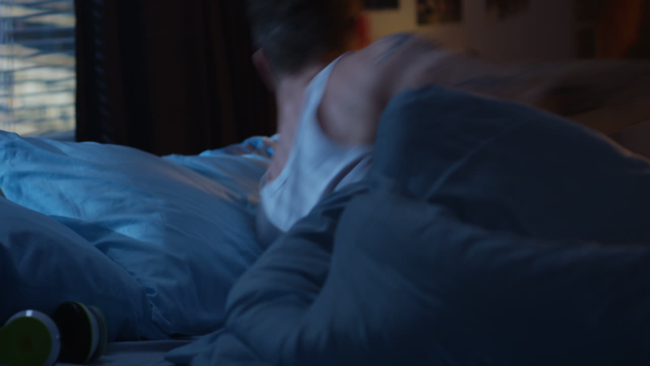 Man Relaxing in Bed at Night
