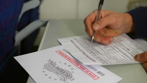 filling out an absentee ballot application form with a pen. the close-up shot emphasizes the details of the form and the "official election material" envelope, highlighting the voting process