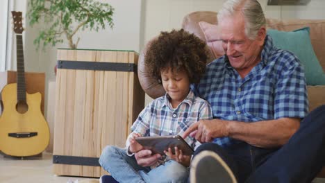 video of biracial grandson and caucasian grandfather playing the guitar together