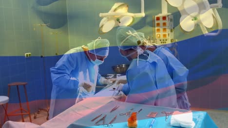 Animation-of-flag-of-colombia-waving-over-surgeons-in-operating-theatre