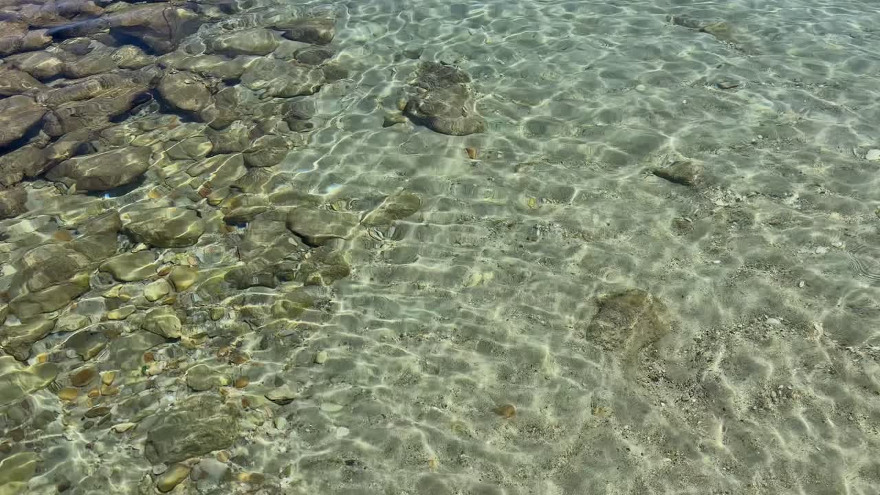 Stunning beach scene in Halkidiki, Greece, with elegant sunbeds facing the crystal-clear turquoise sea. A perfect summer escape in the heart of the Aegean.