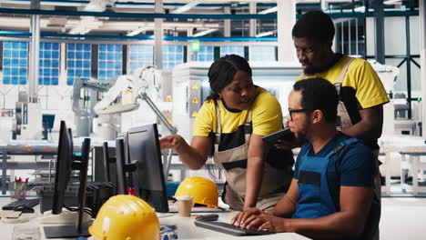 vertical video photovoltaics facility employees evaluating performance of robot arms