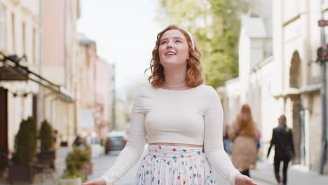 redhead woman taking a deep breath of fresh air relaxing taking a break resting meditating outdoor